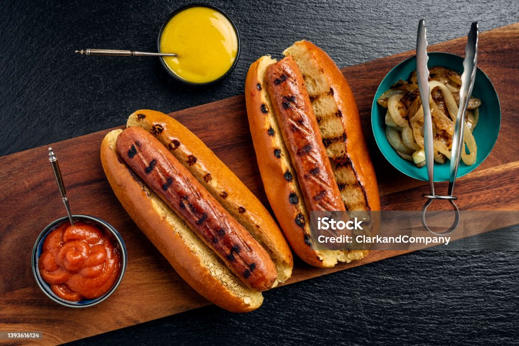 Vegetarian Sausages Overhead view of two veggie hot-dogs in brioche rolls with pickles and relishes. Colour, horizontal format with  some copy space. Hot Dog Stock Photo