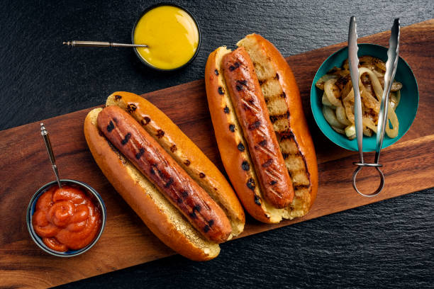 Vegetarian Sausages Overhead view of two veggie hot-dogs in brioche rolls with pickles and relishes. Colour, horizontal format with  some copy space. hot dog stock pictures, royalty-free photos & images