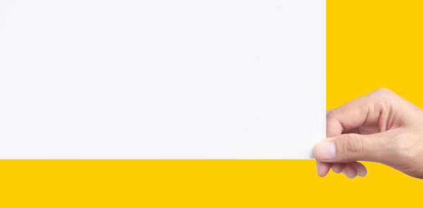 istock Empty space for text.Hand is holding the white blank paper 1393617923