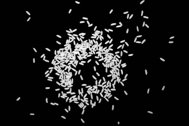 istock Top view, close-up. A pile of white uncooked rice grains, lying flat. 1393618084