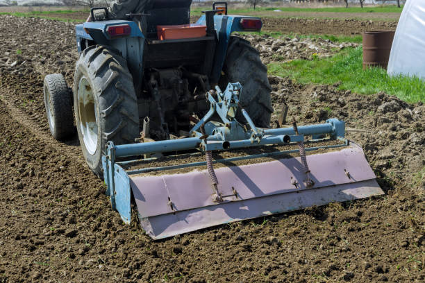 istock Tractor loosens and cultivates soil on field. 1393619402