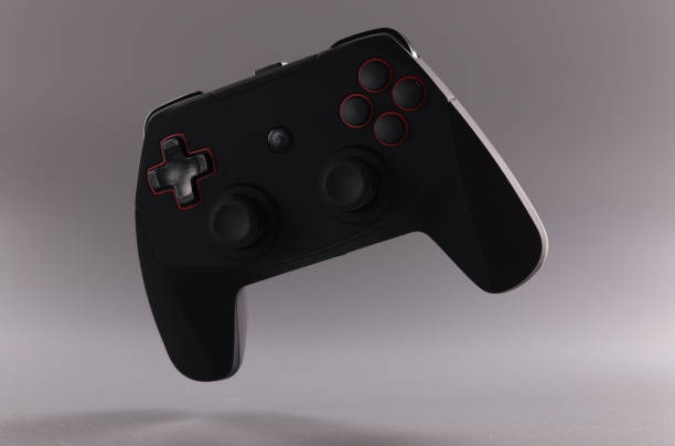 istock Black video game joystick or gamepad on grey background 1393619547