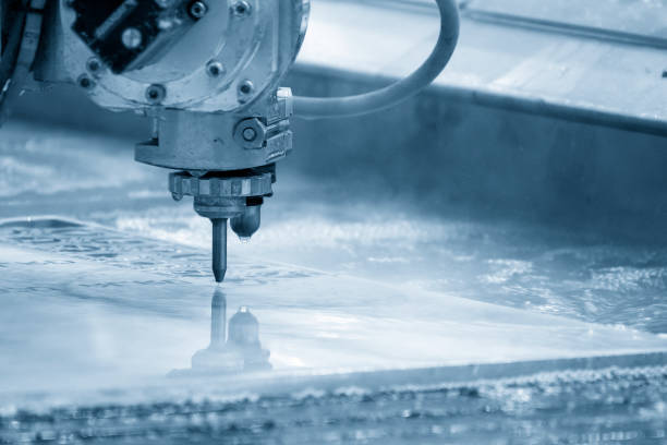 The multi-axis waterjet cutting machine cutting the aluminum plate. stock photo