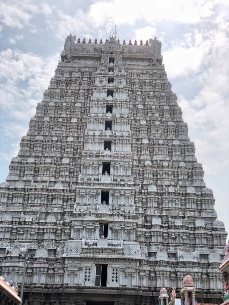istock Ancient Hindu temple tower against blue sky background. 1393620034