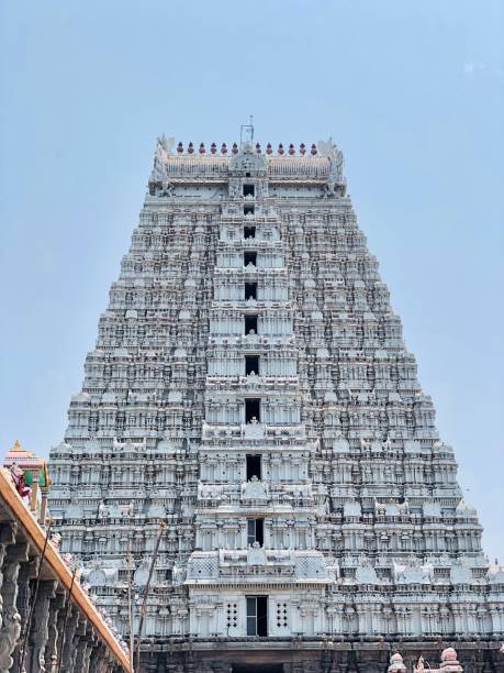 istock Ancient Hindu temple tower against blue sky background. 1393620037