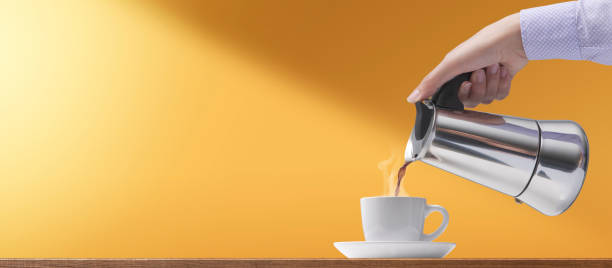 istock Woman pouring hot coffee in a cup 1393623007
