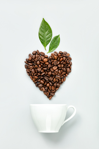 A Close-Up View of a Latte with a Beautiful Heart Shaped Milk Art on Top, Served in a Dark Mug