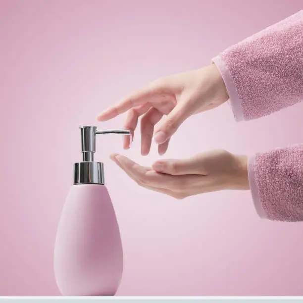 Photo of Woman pumping soap on her hands