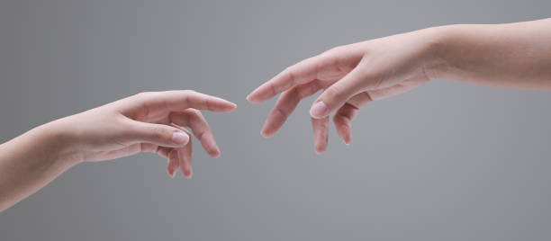 Female hands reaching each other stock photo