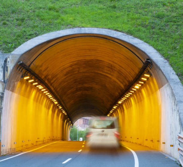 istock car driving at high speed through a tunnel 1393625315