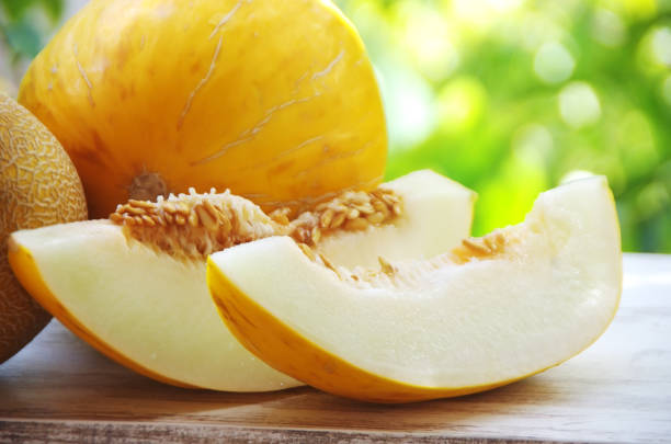 slices of ripe melons on table - melon imagens e fotografias de stock