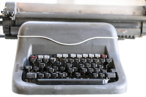 Close up of old adding machine on wooden desk