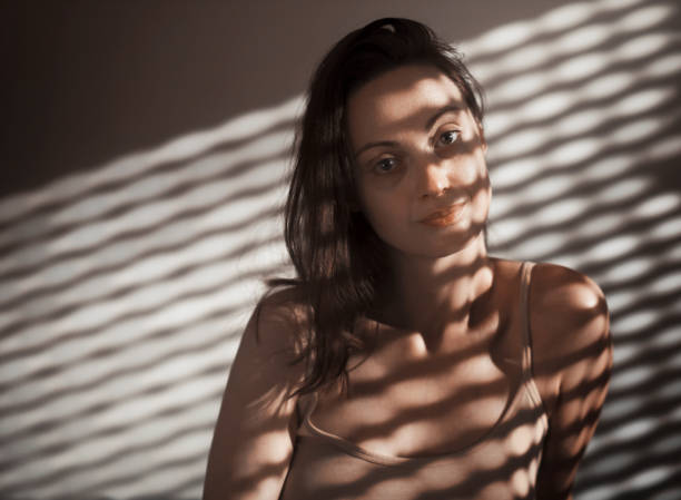 istock Woman with shadows on face 1393628652
