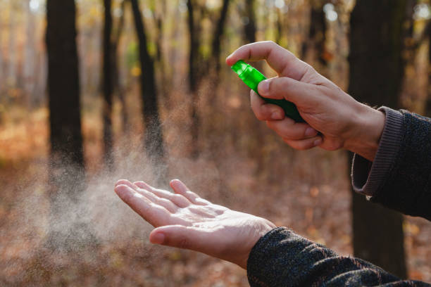 istock Hands spray antiseptic spray. Disinfection in forest 1393629820