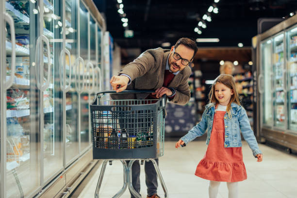 istock Father and daughter in grocery store 1393629832