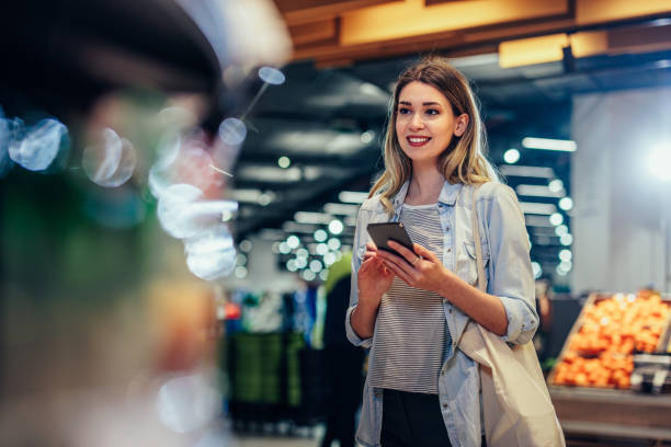 istock Young woman using technology and shopping groceries 1393629879