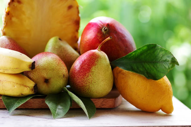 istock fresh healthy tropical fruit  with bananas, pineapple and pears 1393630236