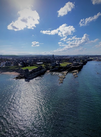 Drone shot of St Andrews in Scotland, coast with sea and architecture on a sunny day