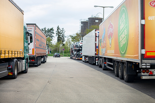 Limburg, Germany - April 23, 2022: Parked trucks on German rest area Limburg at highway A3. Many rest areas are completely overloaded during evening hours due to the high truck traffic density in Germany