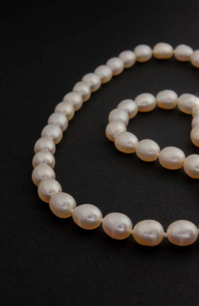 istock Pearl necklace on matte black background. 1393631168