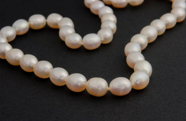 istock Pearl necklace on matte black background. 1393631173
