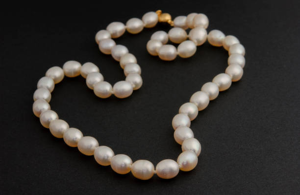 istock Pearl necklace on matte black background. 1393631186