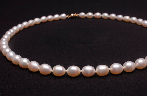 istock Pearl necklace on matte black background. 1393631195