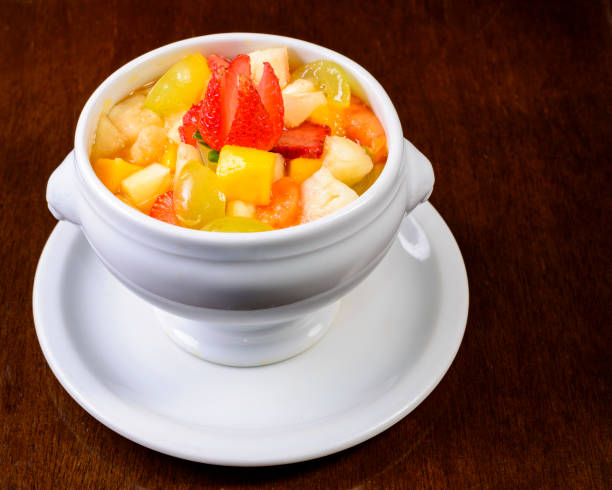 istock Fruit salad with strawberry, green grape, mango and pineapple. Served in a white bowl. 1393631399