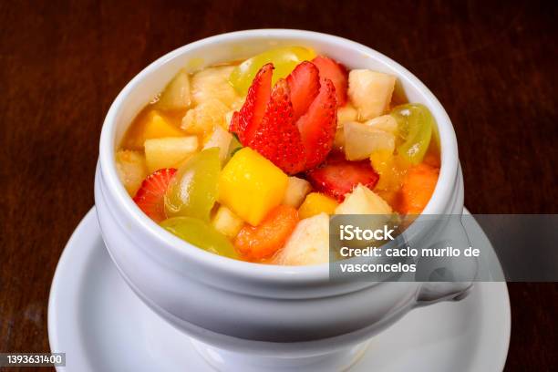 Fruit Salad With Strawberry Green Grape Mango And Pineapple Served In A White Bowl Stock Photo - Download Image Now