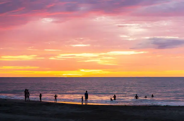 People silhouette swimming in Pacific Ocean on Same beach between Atacames and Sua, Esmeraldas province, Ecuador.
