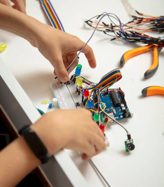istock Top view, little boy designing computer motherboard. 1393635637