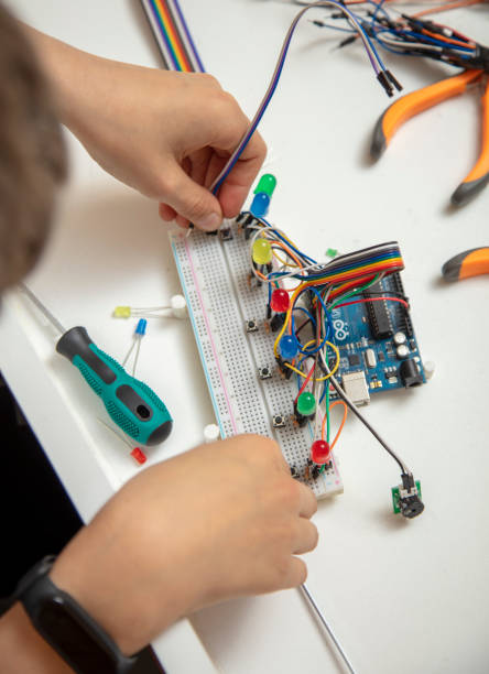istock Top view, little boy designing computer motherboard. 1393636256