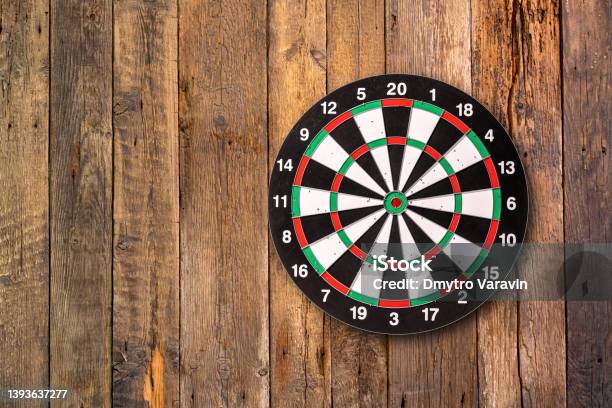 Darts Target Hanging On Wooden Background With Copy Space Stock Photo - Download Image Now