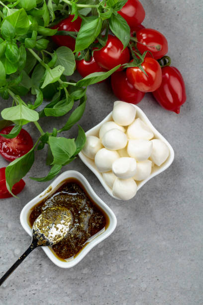 istock Mozzarella cheese with basil, pesto sauce, and tomatoes. 1393637574