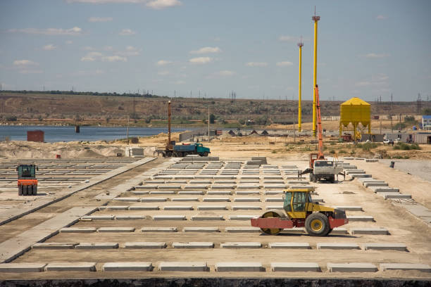 Pier construction. Heavy rollers prepare the ground for the new container terminal.
