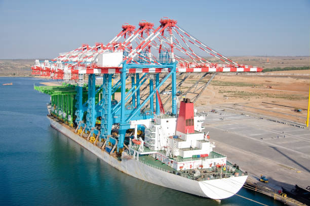 istock Unloading of cranes on the berth. Vessel at the berth with new berthing and rear container cranes STS and RTG 1393638678