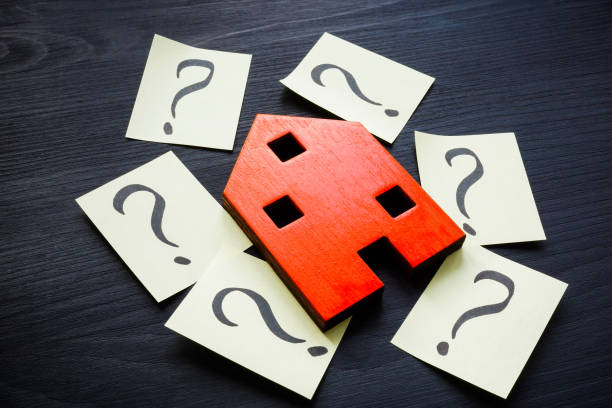 istock Model of house and question marks. Home value concept. 1393639414