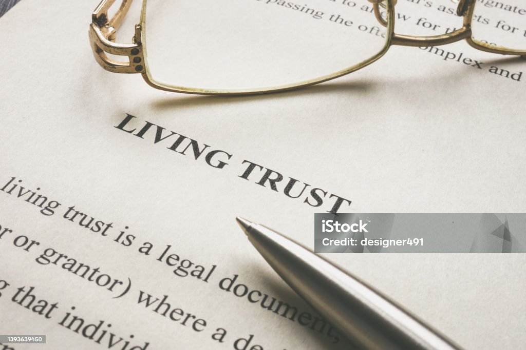 Info about Living trust and glasses on it. Information about Living trust and glasses on it. Will - Legal Document Stock Photo