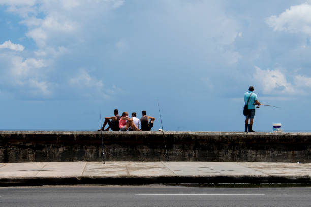 Fishermen on the Malecon in Havana, Cuba stock photo