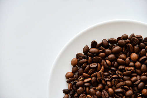 Roasted coffee beans on a white plate