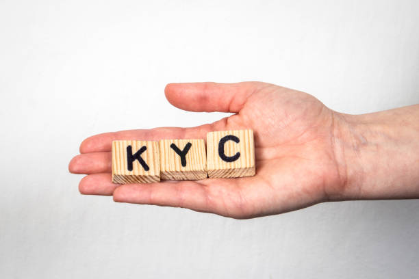 istock KYC Know Your Customer. Alphabet letters in a woman's hand on a white background 1393643482
