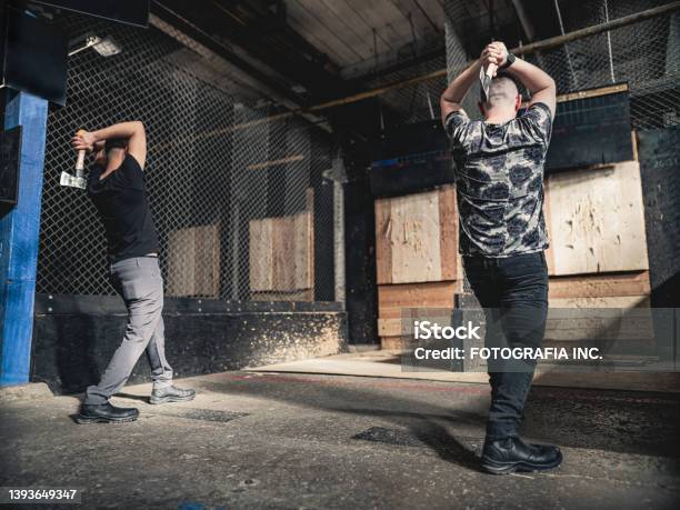 Young Gay Men At The Axe Throwing Game Room Stock Photo - Download Image Now - Axe, Throwing, Axe Throwing