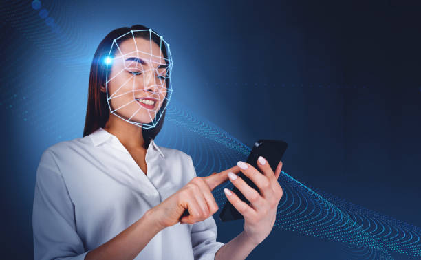 istock Office woman with smartphone, using facial scanner smiling 1393650565