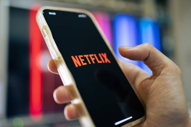 Netflix Bangkok, Thailand - April 25, 2022 : iPhone 13 showing its screen with Netflix application. ultra high definition television stock pictures, royalty-free photos & images