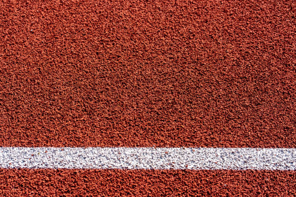 istock Texture of red athletics track with white lines 1393654603
