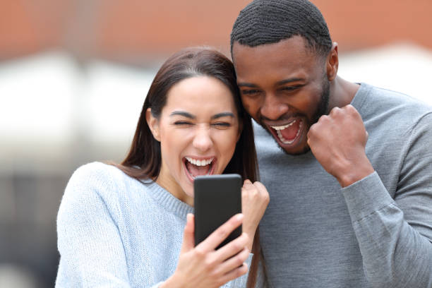 istock Excited interracial couple checking smart phone 1393657334