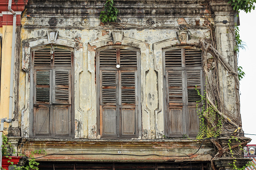 Medan, Sumatra, Indonesia - January 16th 2024:  Window in Chinese style in an old wall in a building in the center of the main city on Sumatra