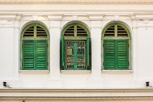 Beautiful ruined vintage wooden windows of an old Chinese shop house in the heritage town of Georgetown in Penang, Malaysia.