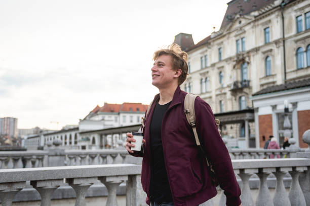 istock Backpacker drinking coffee and relaxing in an European city 1393662508