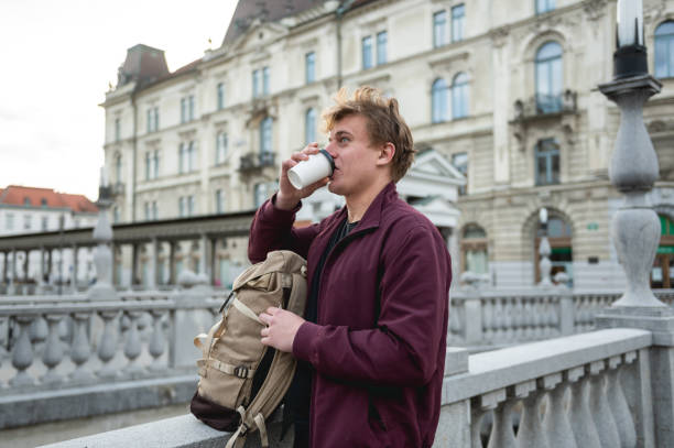 istock Backpacker drinking coffee and relaxing in an European city 1393662513